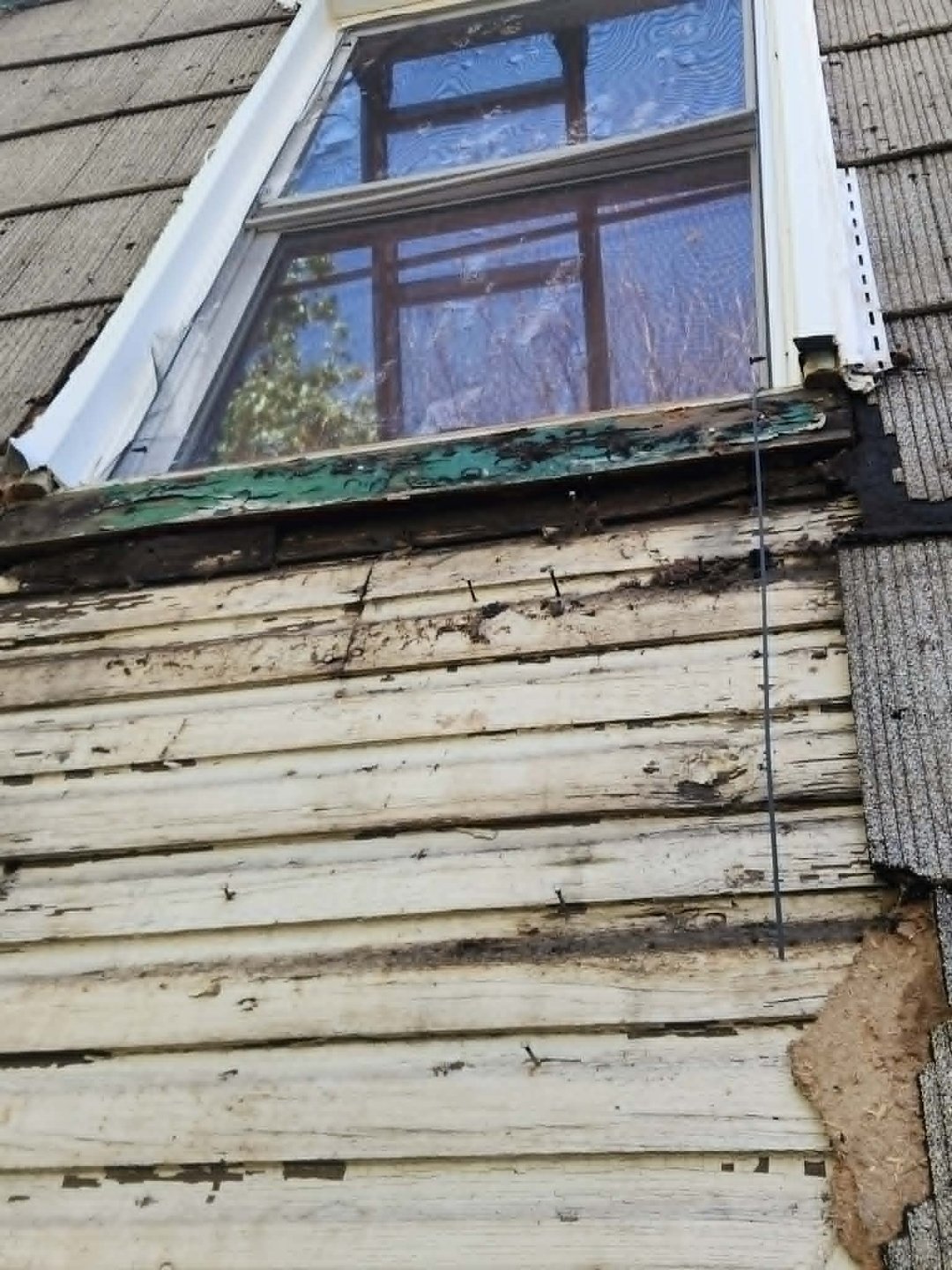 Severely rotted wood siding